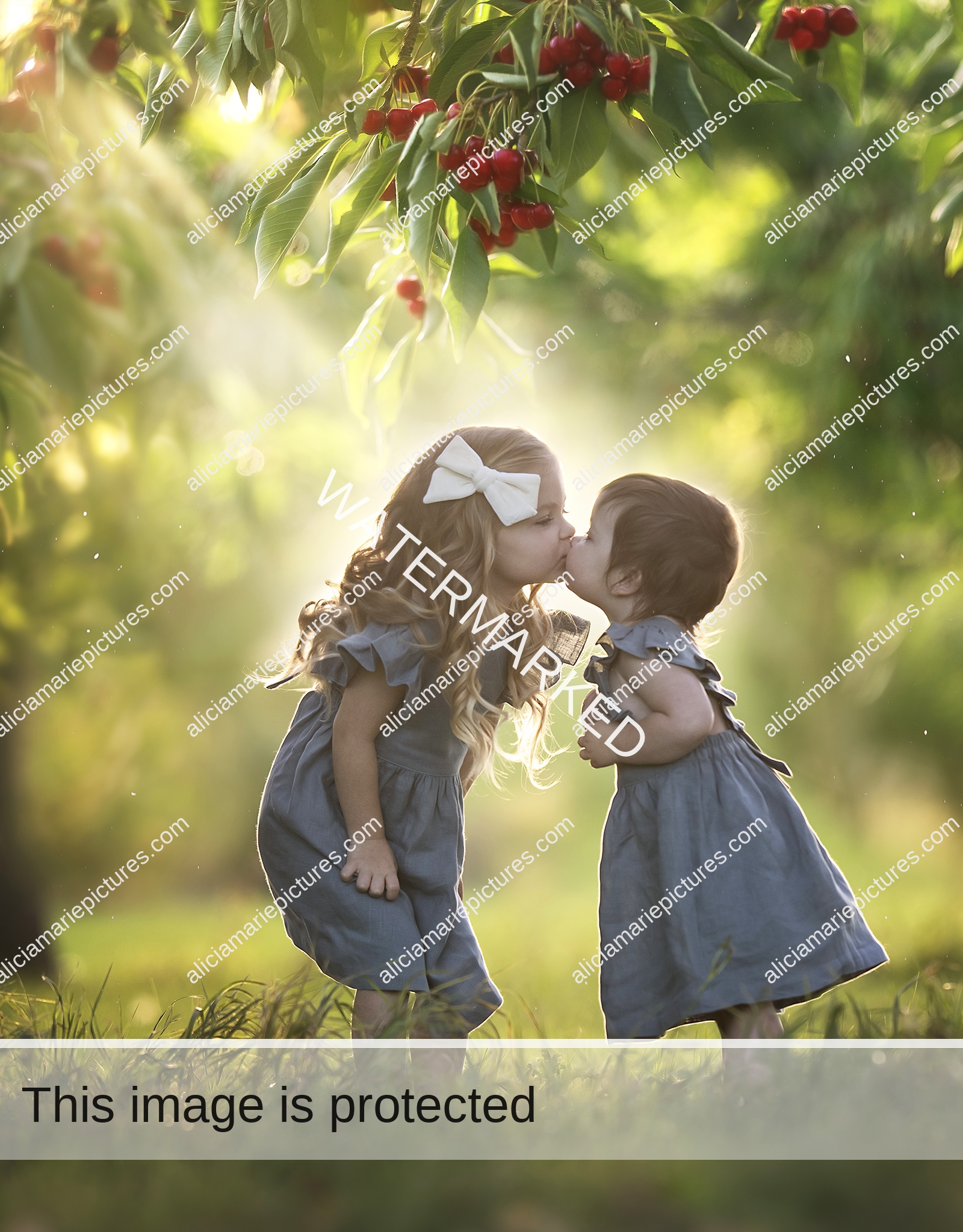 Fine art photography of two little girls sisters kissing under cherry berry tree in autumn during golden hour