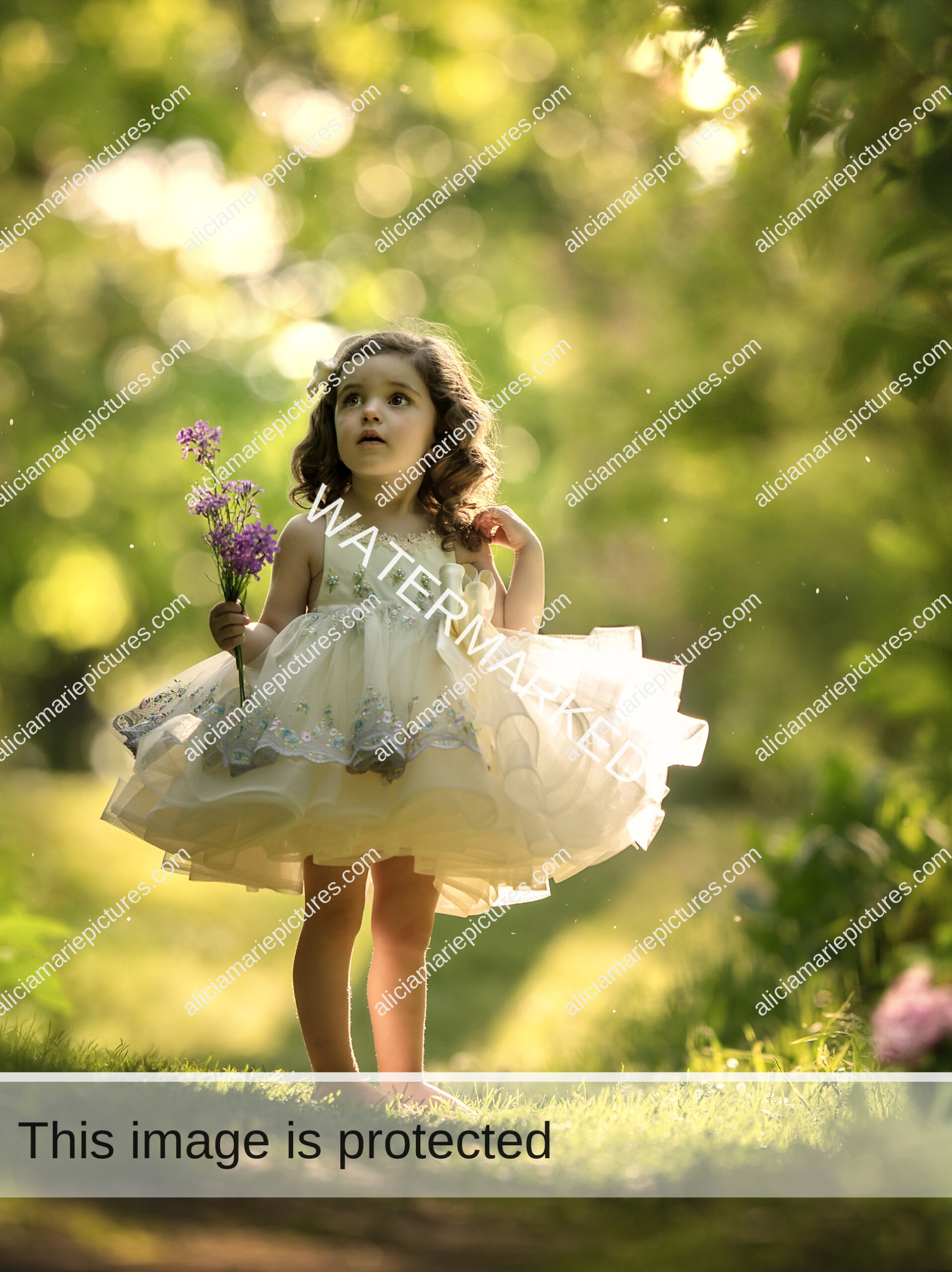 Fine art photography little girl holding purple flowers standing in couture dress at golden hour